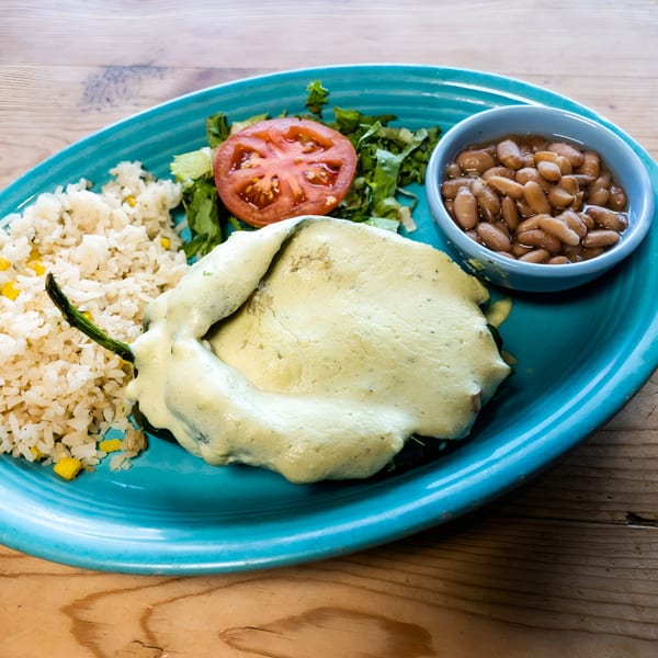 El Chaparral's chile relleno with rice, beans, lettuce, and tomato on a blue plate.